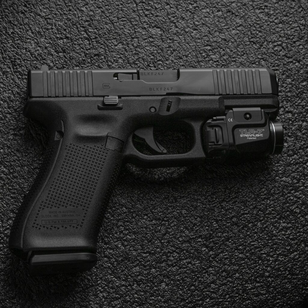 Glock 45 handgun with a flashlight and a black background